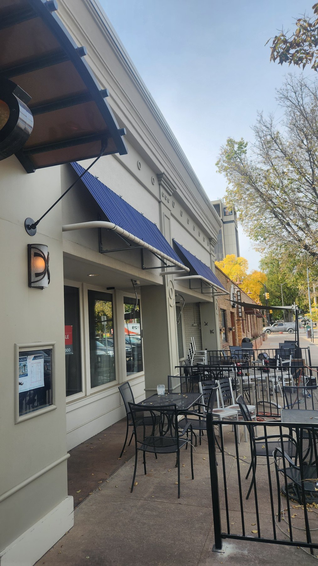 Blue fabric awnings above the Jay’s Bistro patio before removal.